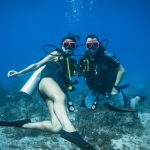 Divers hovering midwater, in Jamaica.